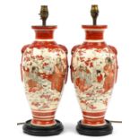Pair of Japanese Kutani vase table lamps raised on hardwood bases, hand painted with figures and
