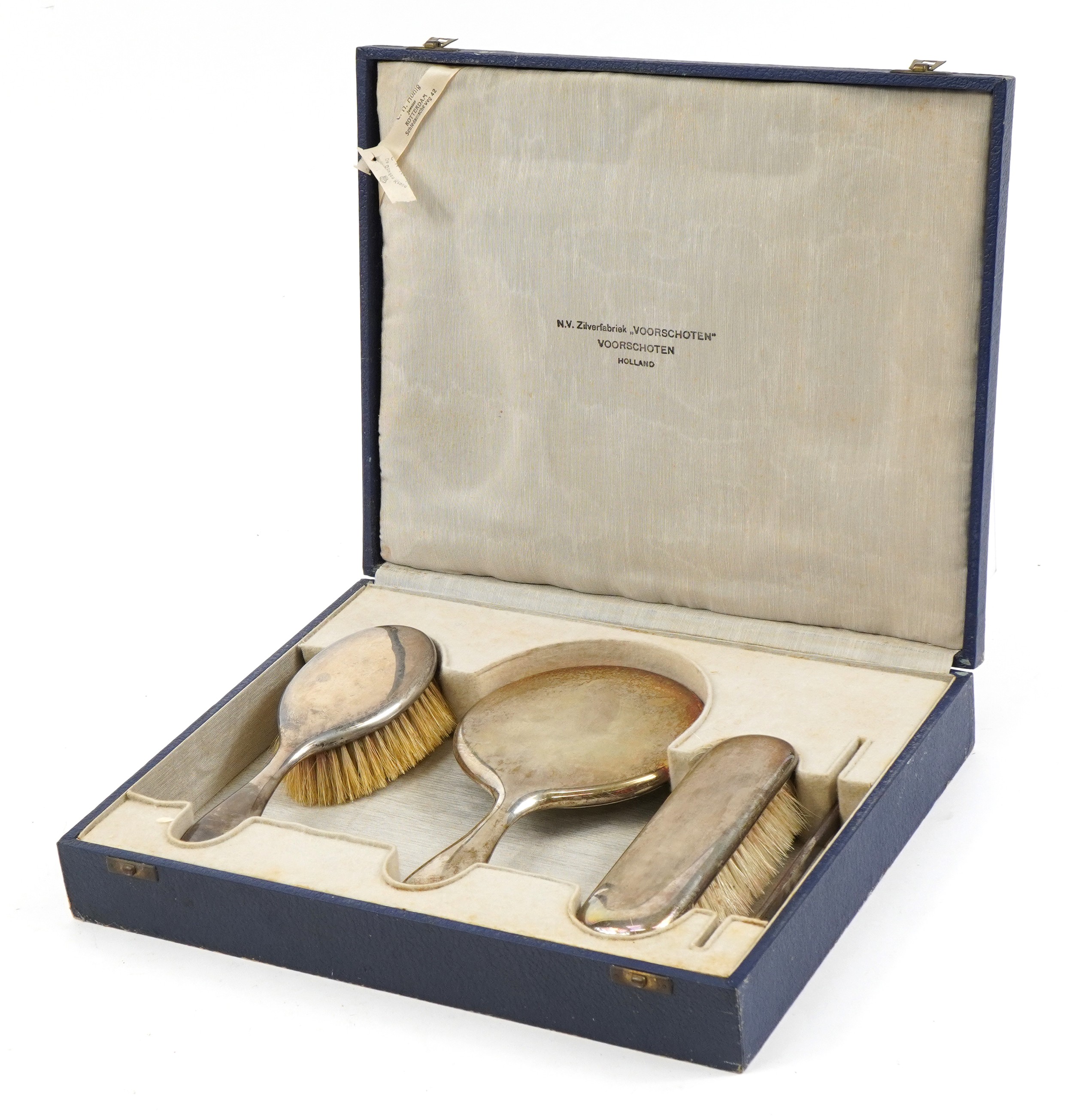 Dutch silver three piece dressing table set housed in a velvet and silk lined fitted case,