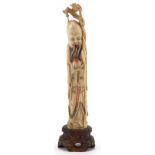 Well detailed bone carving of an oriental Chinese elder on a wooden base, 18cm high