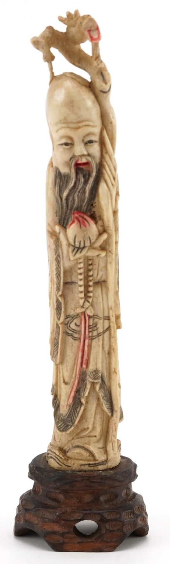 Well detailed bone carving of an oriental Chinese elder on a wooden base, 18cm high