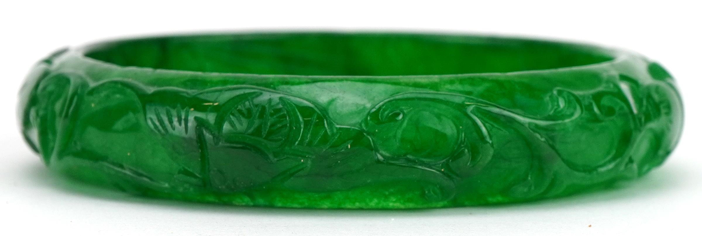 Chinese green jade bangle carved with foliage, 7cm in diameter, 46.8g - Image 2 of 2