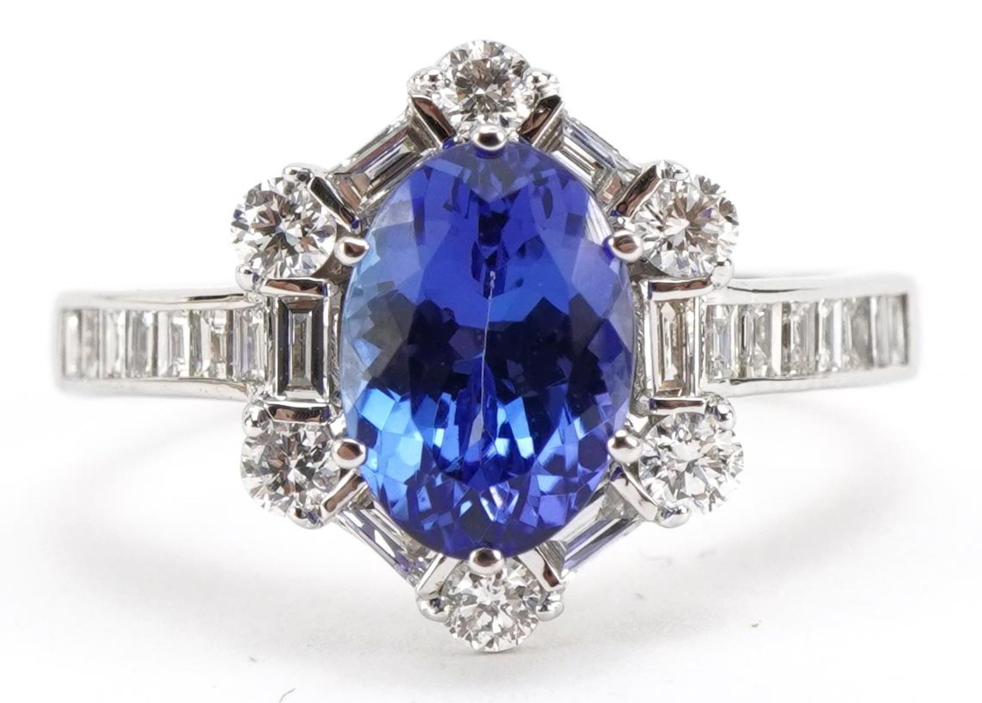 18ct white gold tanzanite and diamond halo ring with baguette cut shoulders, total tanzanite