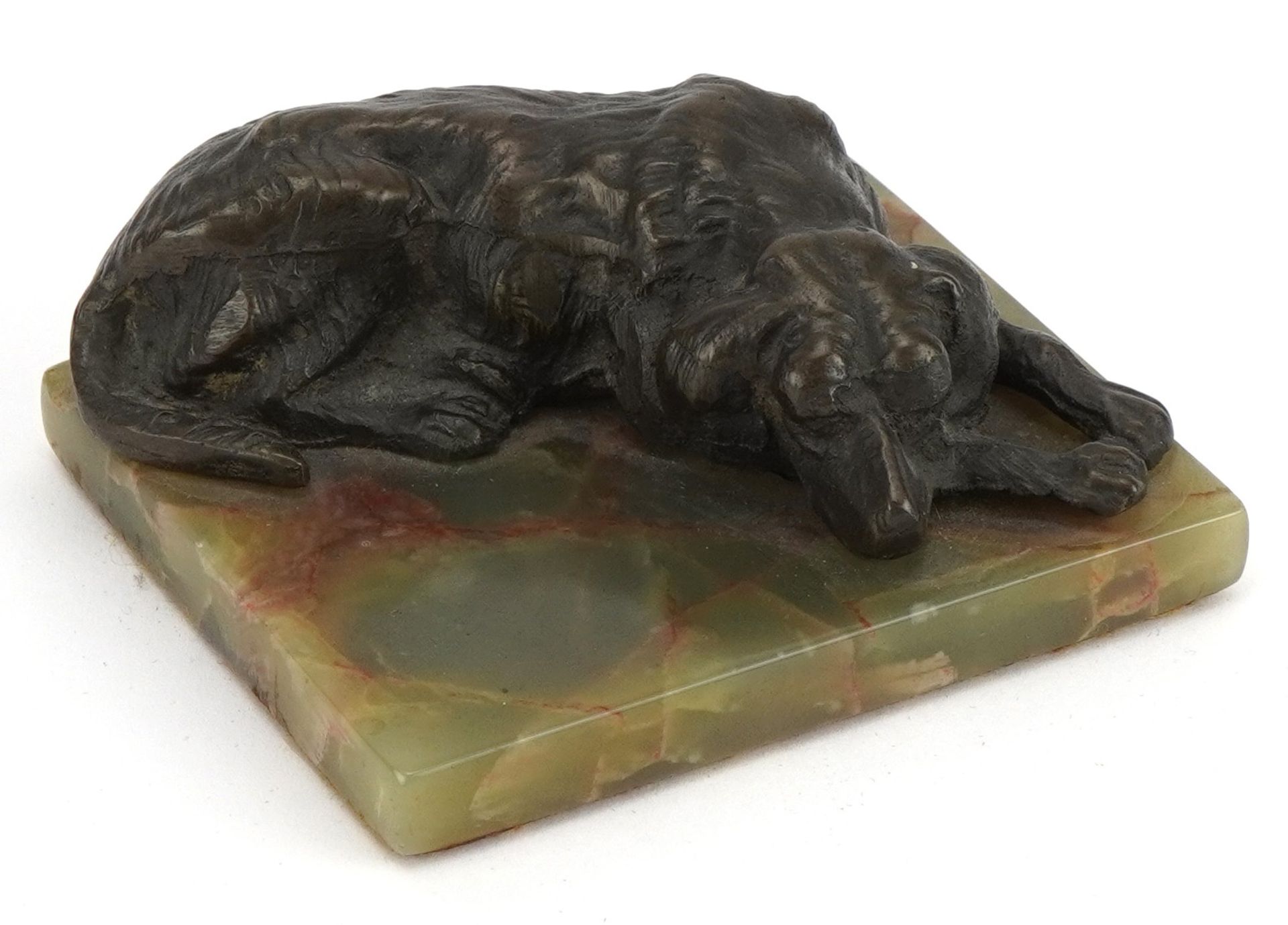 Rectangular green onyx desk paperweight surmounted with a patinated spelter dog, 9cm wide