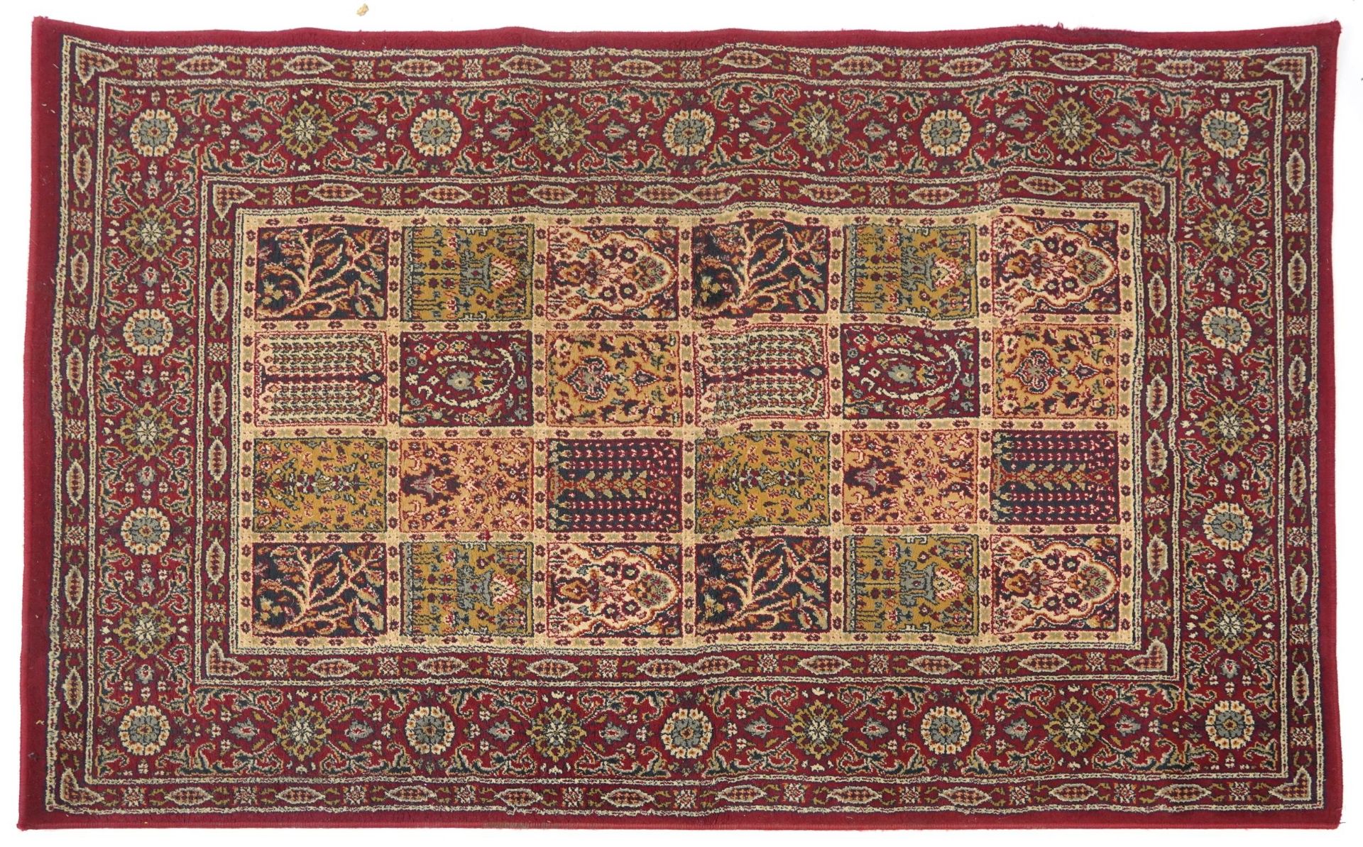 Rectangular Persian rug, the central field having a repeat tree design, the red ground borders