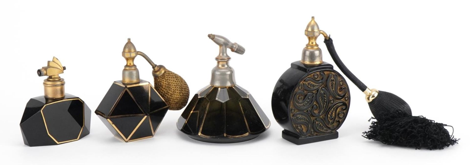 Four French Art Deco black glass atomisers including three with gilt decoration, one stamped