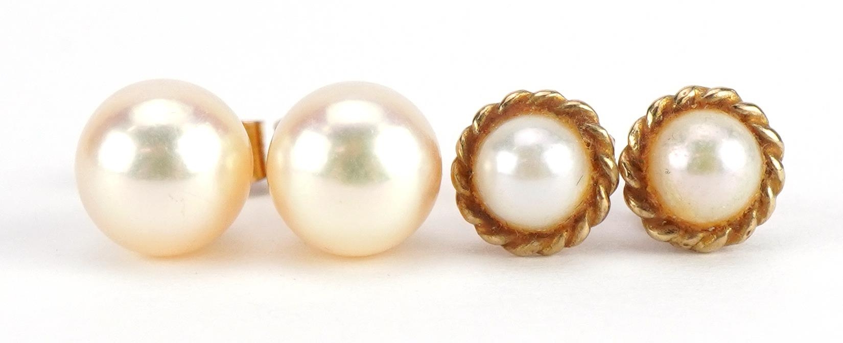 Pair of 9ct gold pearl stud earrings and a similar yellow metal example, the backs stamped 9