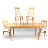 Ercol light elm rectangular extending dining table with four stick back chairs, the table 80cm H x