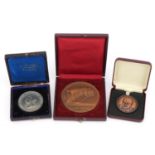 Three medallions with fitted cases including Winston Churchill and Royal Jubilee Exhibition