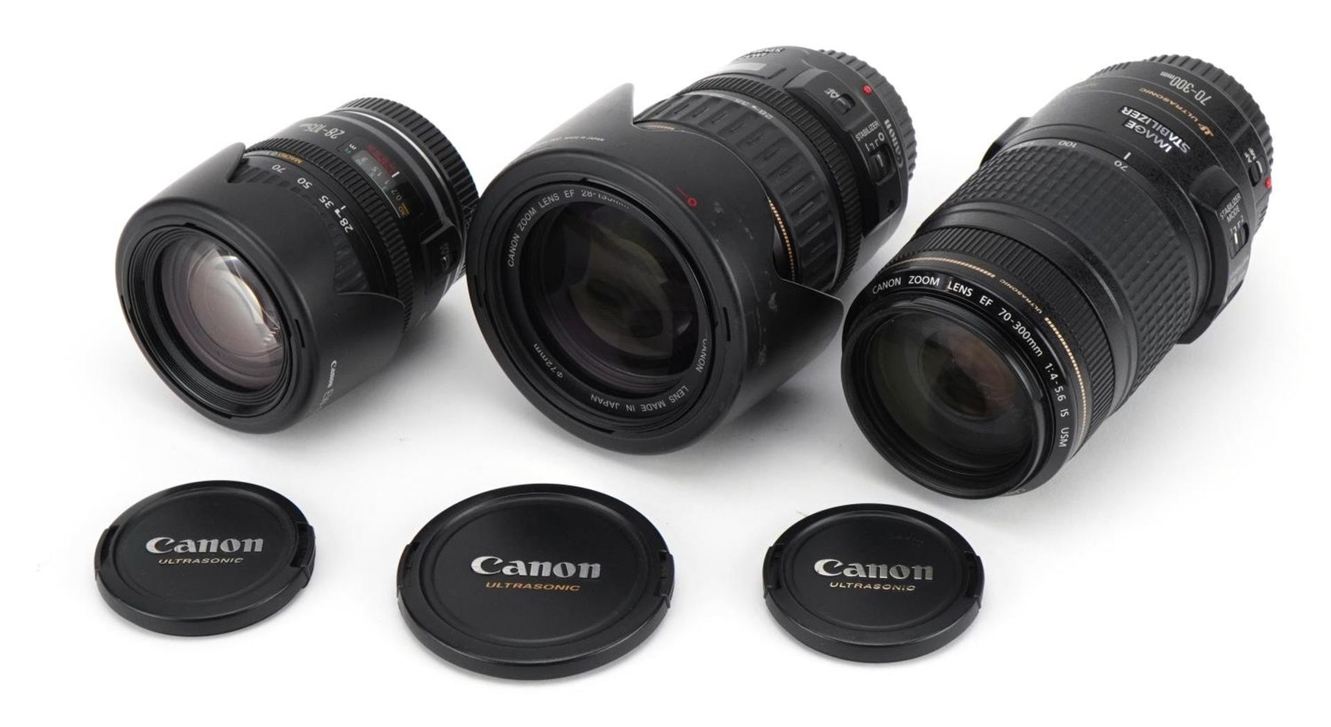 Three Canon camera lenses comprising 28-105mm, 70-300mm and 28-135mm