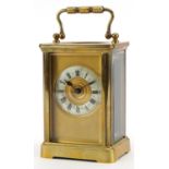 French brass cased carriage clock with enamelled chapter ring having Roman numerals, 11cm high