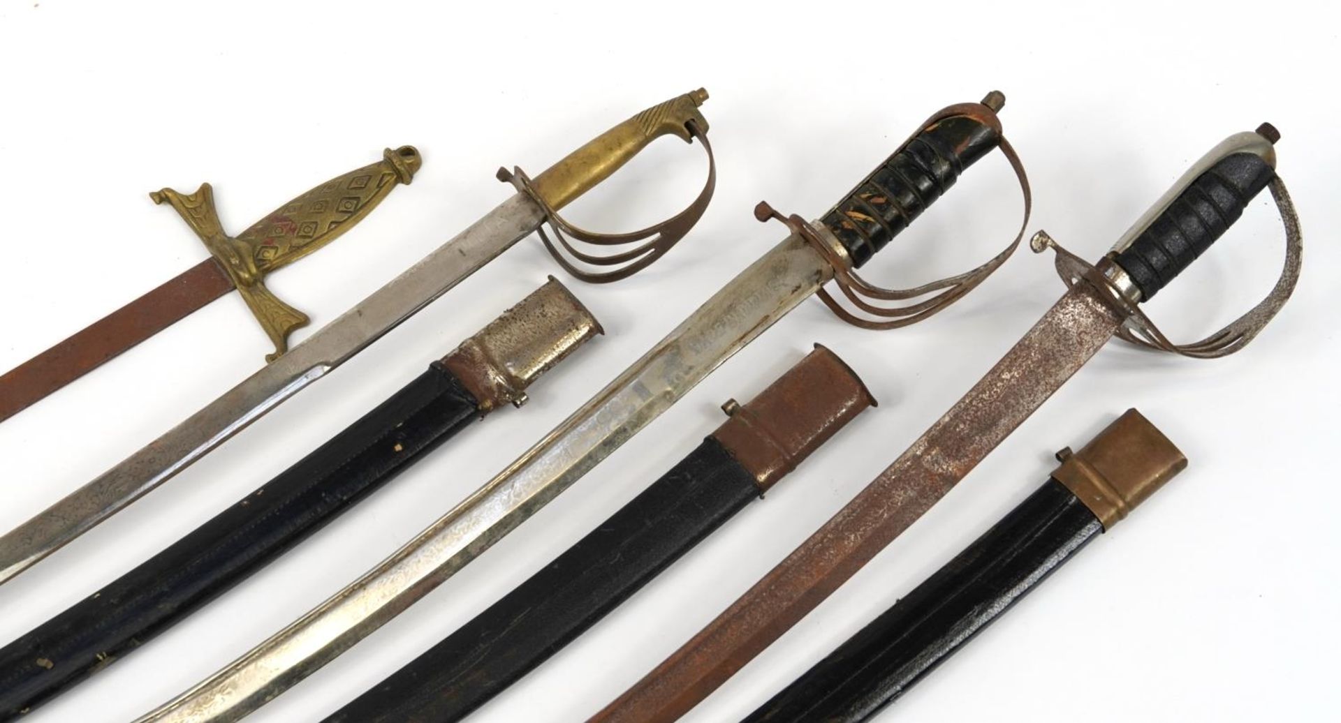 Three Indian swords with scabbards and a medieval style wall hanging sword, the largest