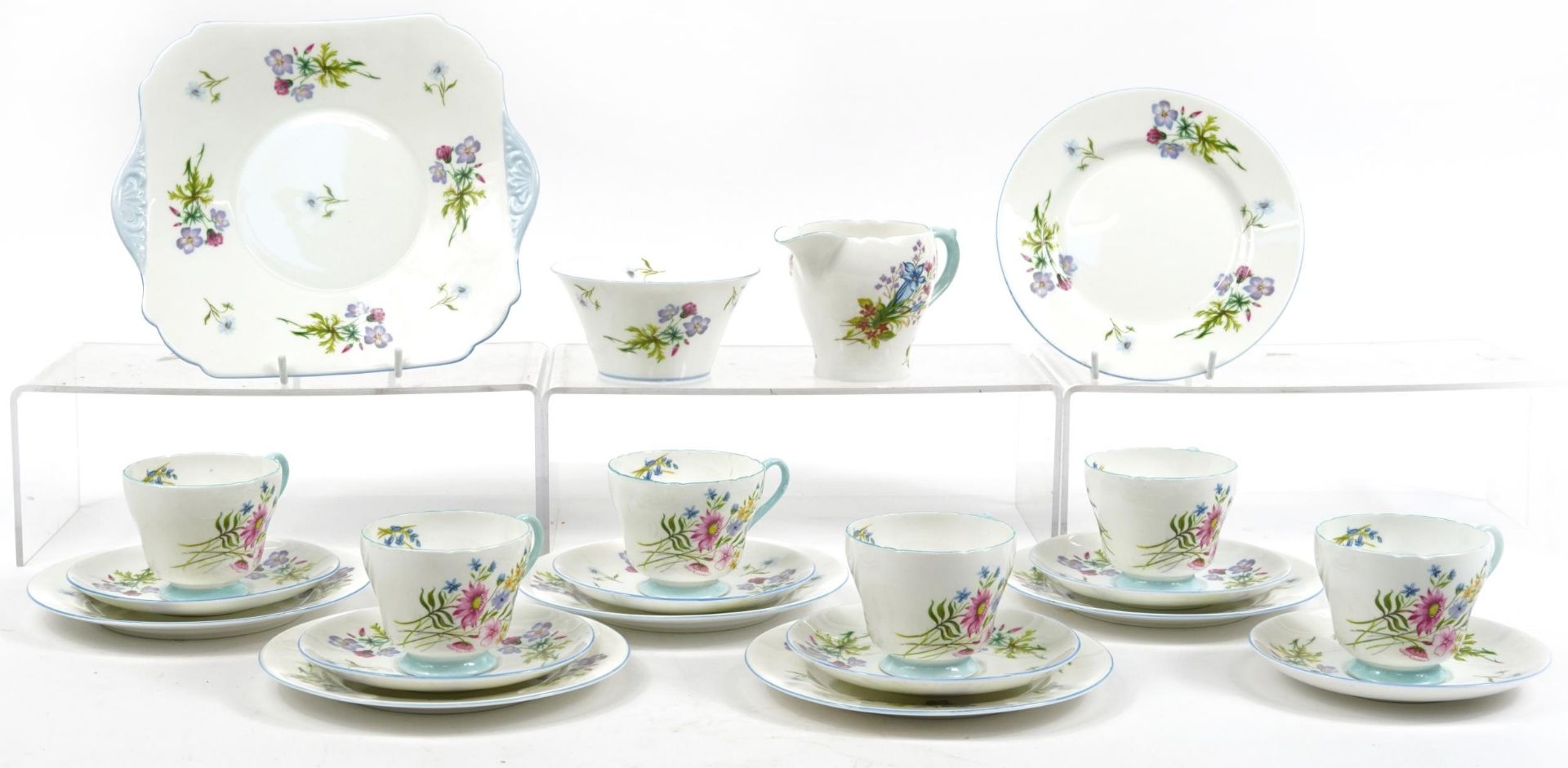 Shelley Wild Flowers teaware comprising six trios, milk jug, sugar bowl and cake plate, the