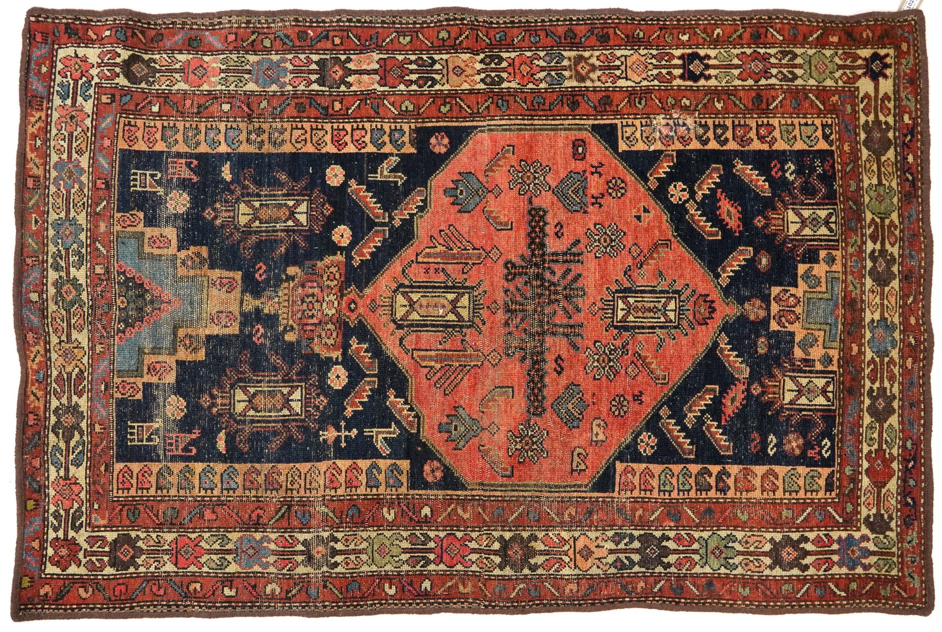 Rectangular Afghan red and blue ground rug with all over geometric and animal design, 177cm x 120cm