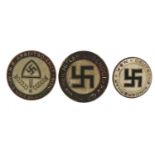 Three German military interest badges, the largest 2.2cm in diameter