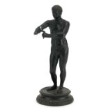 Antique verdigris patinated bronze study of a study nude male raised on a circular base, 28cm high