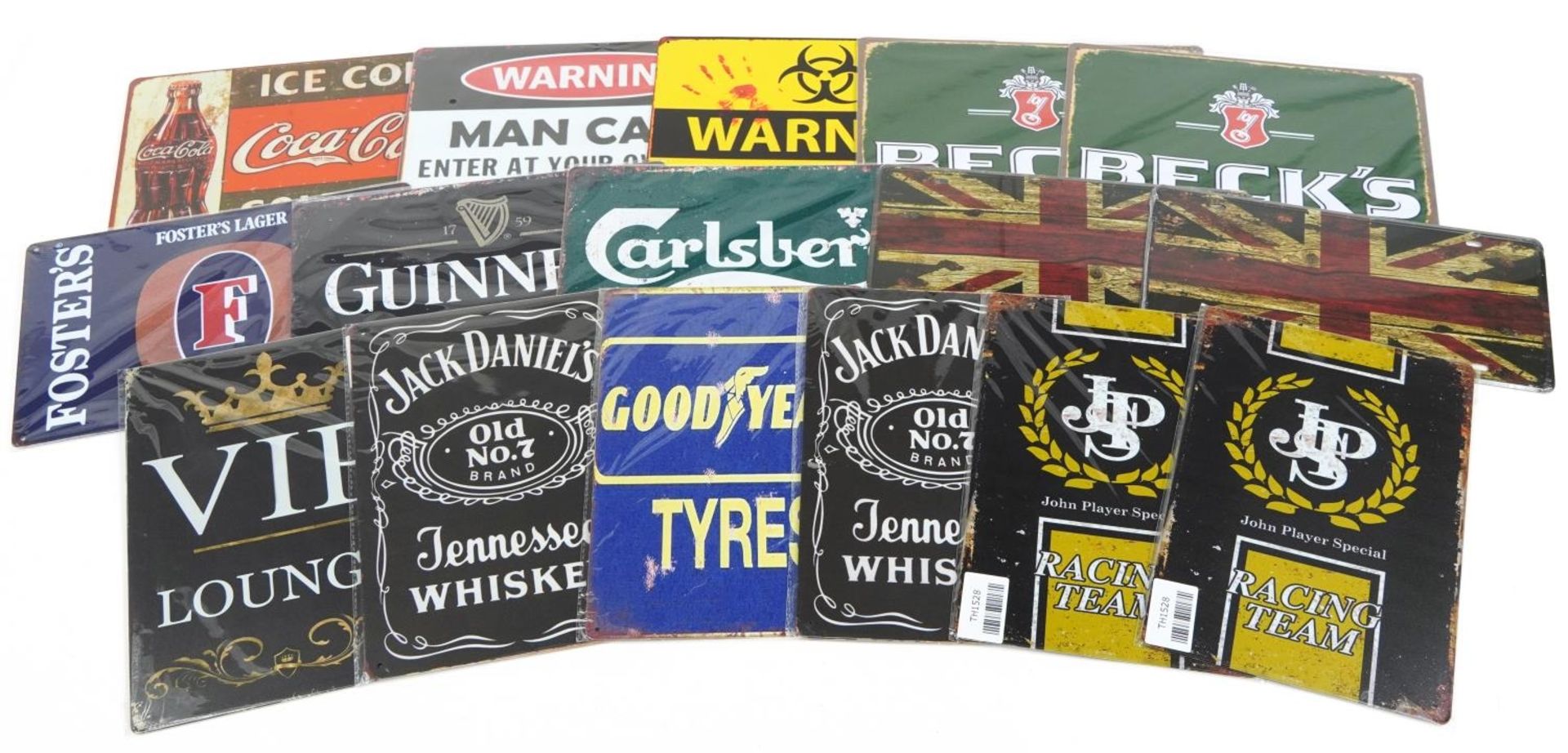 Sixteen tin advertising and man cave signs including J P S, Jack Daniels, Carlsberg, Guinness and