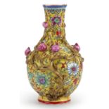 Chinese porcelain yellow ground vase decorated in relief with fruit, hand painted in the famille