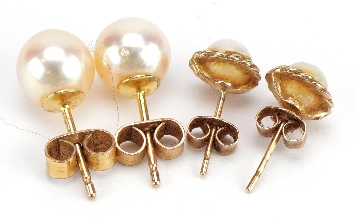 Pair of 9ct gold pearl stud earrings and a similar yellow metal example, the backs stamped 9 - Image 2 of 2