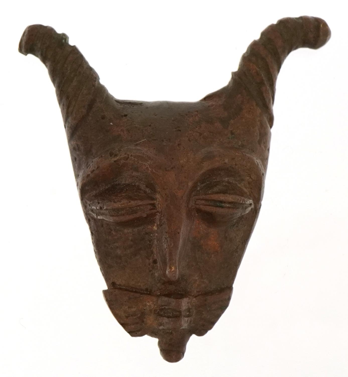 African patinated bronze mask, 5cm high