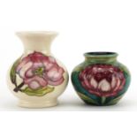 Two Moorcroft Pottery vases including one hand painted in the Magnolia pattern, the largest 9.5cm