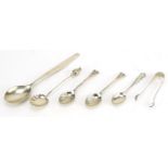 Five silver spoons and a pair of silver sugar tongs, three with shell shaped bowls, the largest 19cm