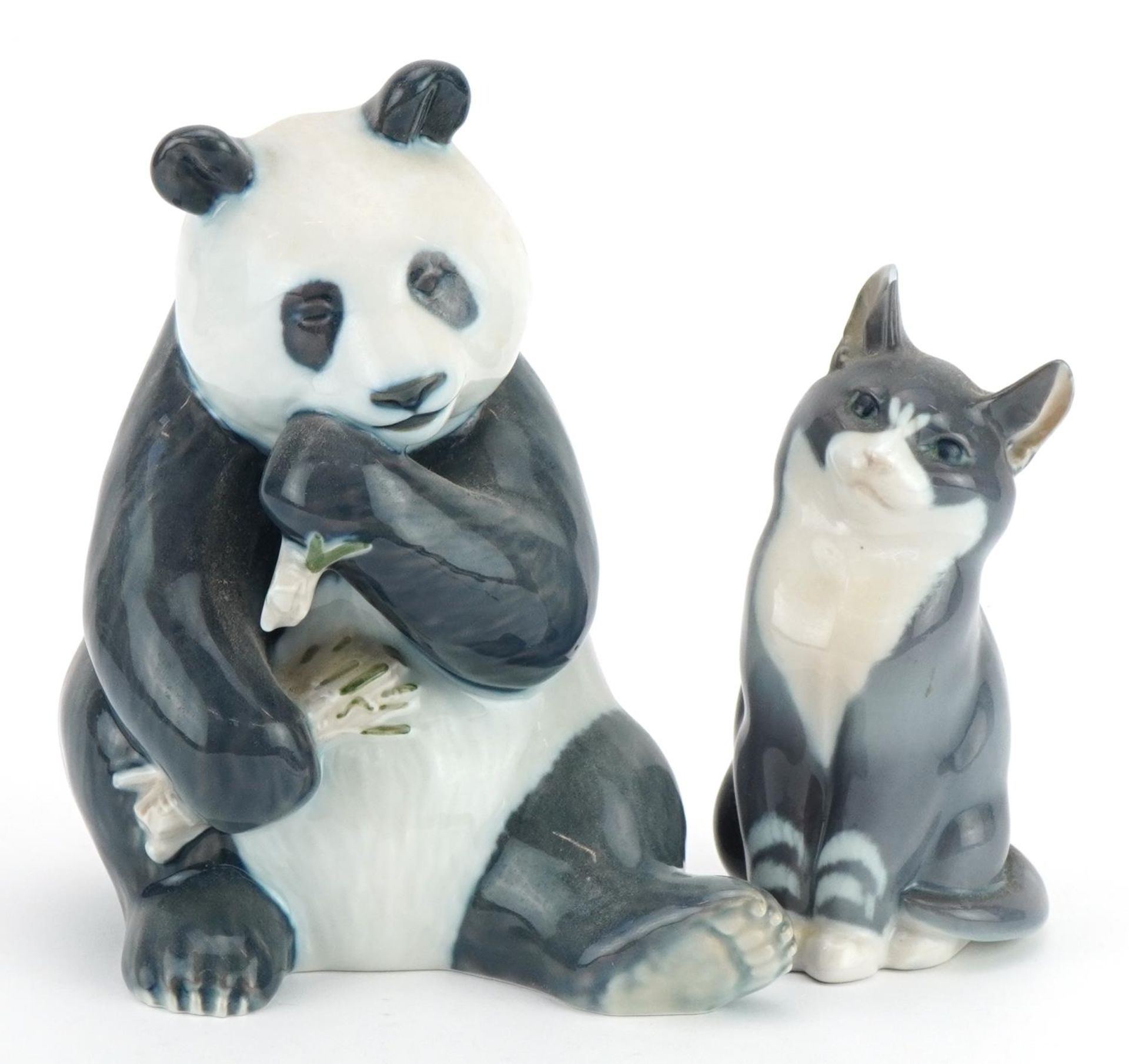 Royal Copenhagen, Danish porcelain seated panda and cat, the largest 17.5cm high For further