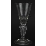 Eighteenth century glass with hollow stem on folded foot, 14cm high For further information on