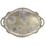 Heavy oval silver serving tray with twin handles and pierced gallery, indistinct hallmarks, engraved