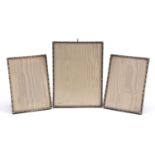 A E Jones, set of three Elizabeth II silver bamboo design photo frames, various dates, the largest