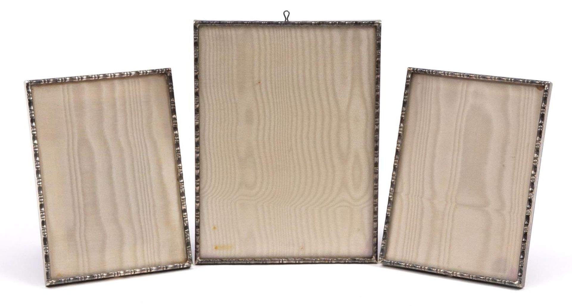 A E Jones, set of three Elizabeth II silver bamboo design photo frames, various dates, the largest