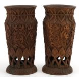 Pair of Indian hardwood pierced vases carved with foliage, each 23cm high For further information on
