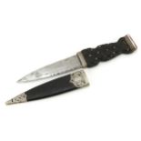 Victorian Scottish sgain dubh with silver mounts, carved ebony knot grip and steel blade, the silver