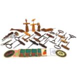 Antique and later corkscrews, bottle openers and beer mats including an example with hardwood