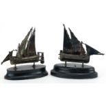 Two Maltese miniature silver sailing boats raised on ebony bases, the largest 10cm high For