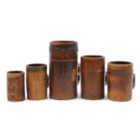 Five antique Tudor style treen tankards including three metal bound, various impressed marks, the