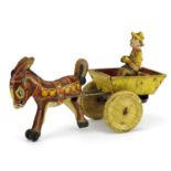 Vintage Marx Toys tinplate clockwork model of a donkey pulling a cart, 21cm in length For further