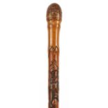 Good Japanese bamboo walking stick finely carved with mythical animals and fish, signed with