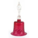 Victorian glass table bell with writhen cranberry glass bowl and white overlaid rim, 28cm high For