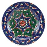 Turkish Ottoman Iznik shallow charger hand painted with stylised flowers, 36cm in diameter For