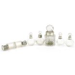 Five Victorian and later silver mounted scent bottles and a cut glass bottle with stopper, the