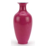 Chinese porcelain vase having a pink glaze, four figure iron red character marks to the base, 23.5cm