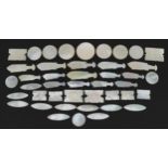 Collection of Chinese Canton mother of pearl gaming tokens, some in the form of fish, the largest
