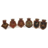 Six mid 20th century naval interest hand painted oak ship's tompions including HMS Dragon, HMS
