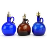 Three antique coloured glass whisky decanters with silver plated mounts including two Bristol blue