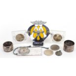 Objects including five pound coin, AA car badge and two silver napkin rings For further