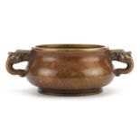 Chinese patinated bronze censer with animalia twin handles, four figure character marks to the base,