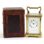 Brass cased carriage clock with fitted travel case, the enamelled dial having Roman numerals,