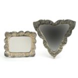 Two Turkish 900 grade silver backed mirrors embossed with flowers, the largest 16.5cm wide For