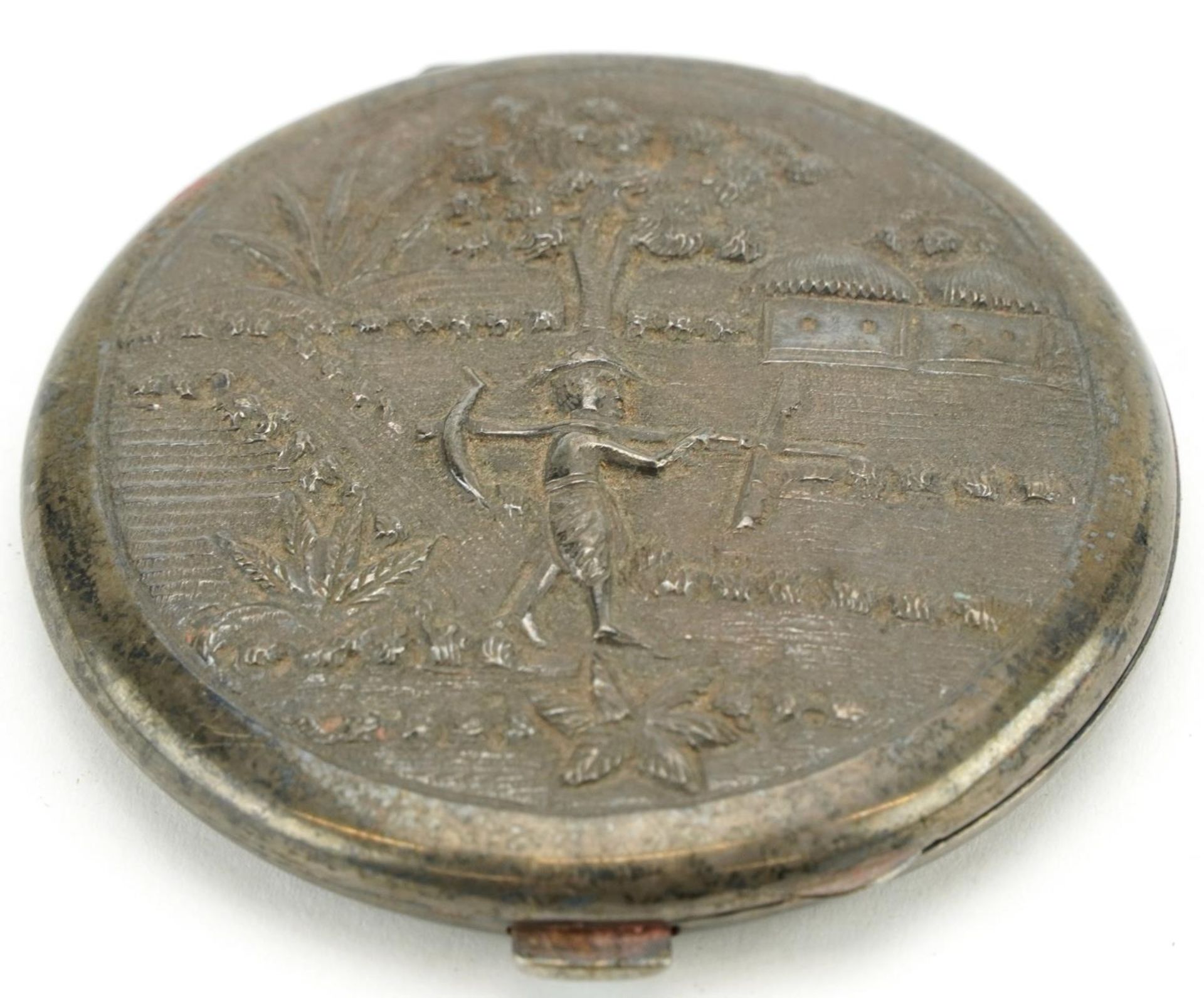 Anglo Indian sterling silver circular compact embossed with a farmer, 7.5cm in diameter, 93.6g For