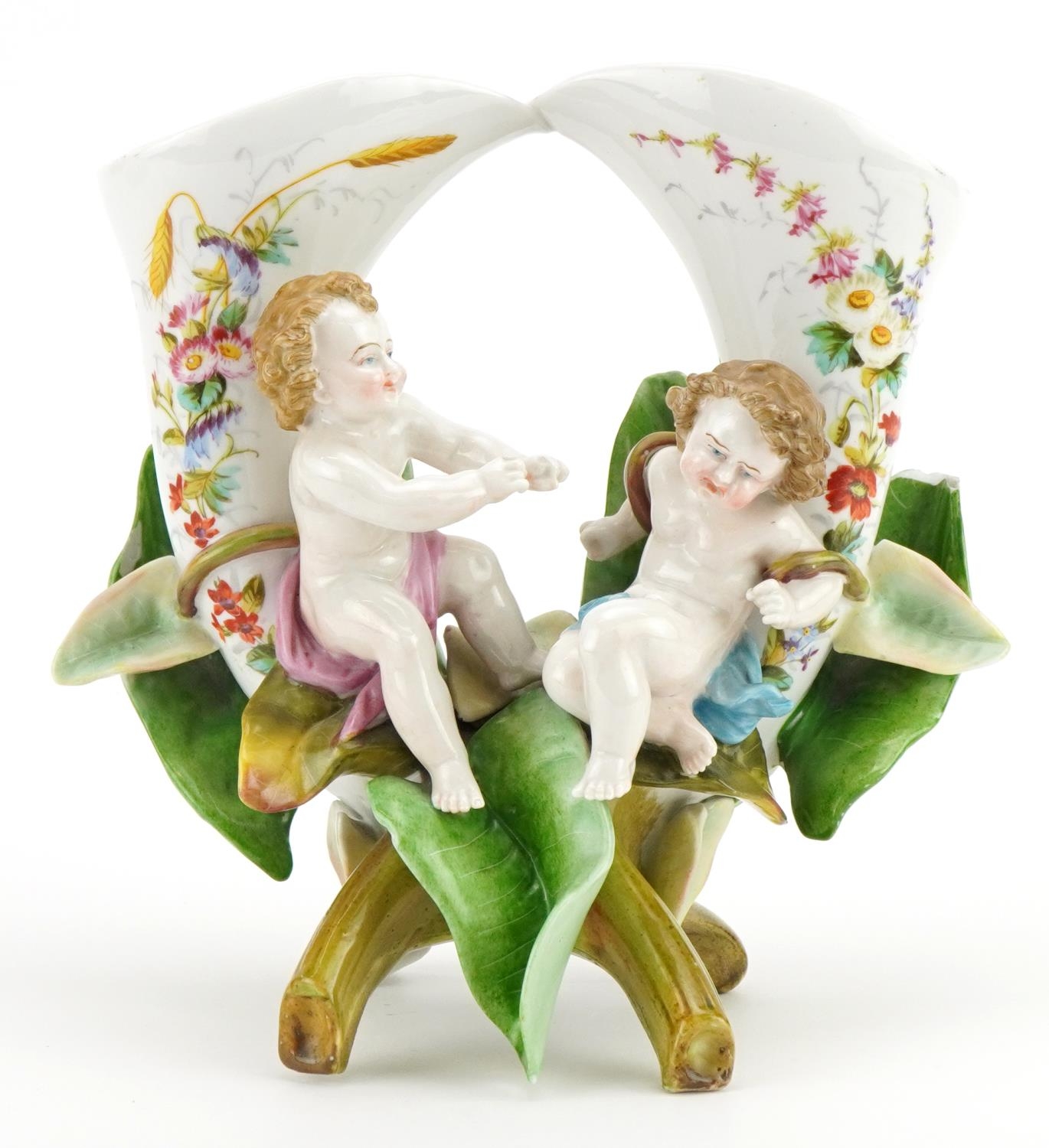 German porcelain naturalistic twin vase surmounted with Putti, hand painted with flowers and